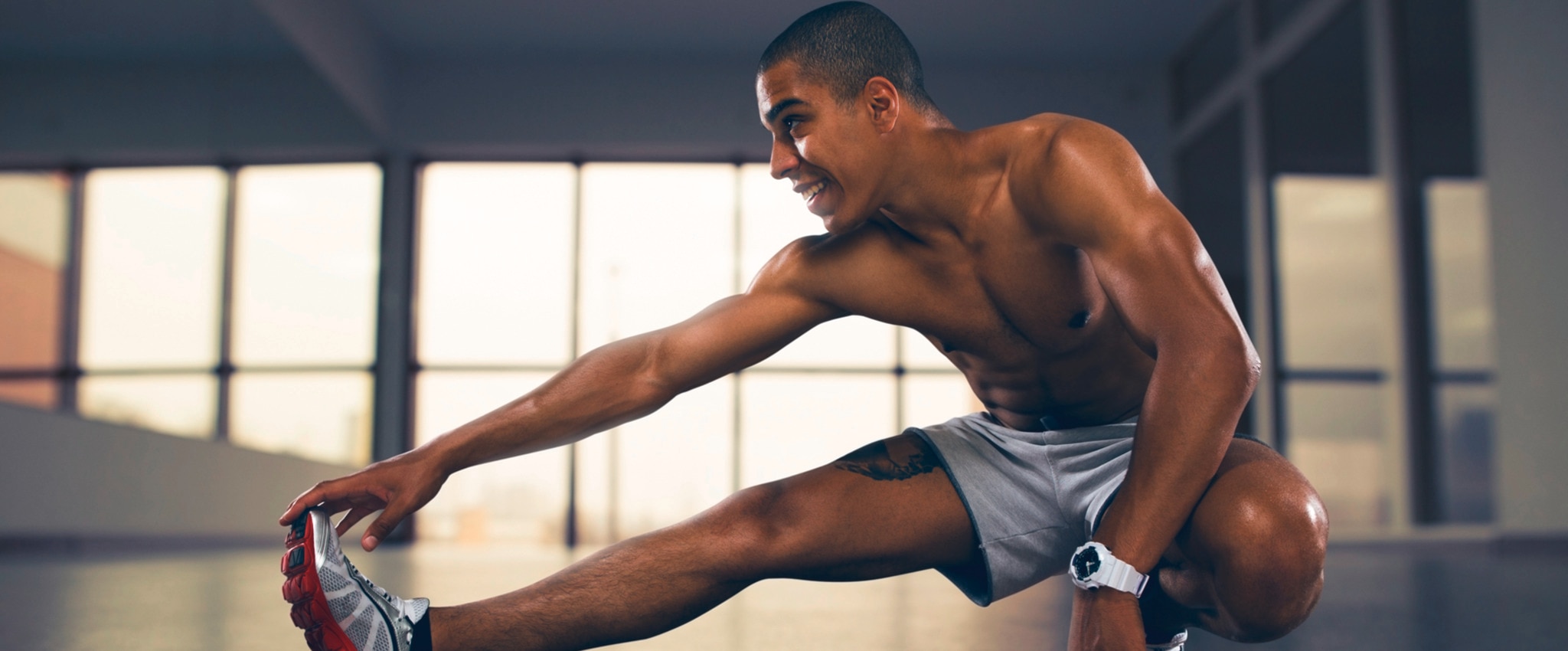 Man stretching his legs after leg workout