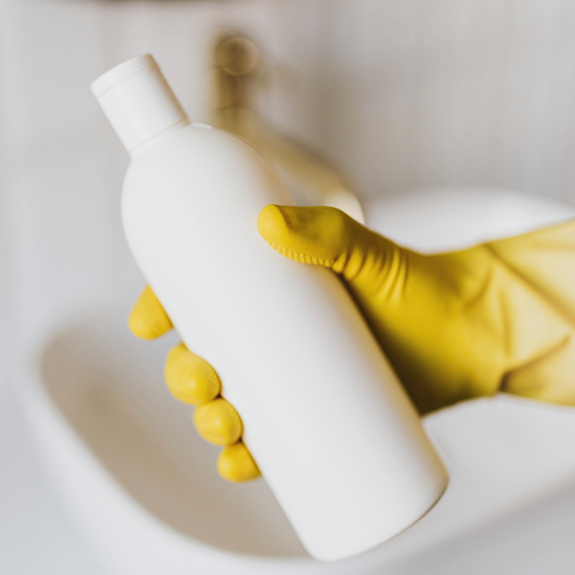 Recycled Beauty Packaging: A Gloved Hand Holding a Plastic Bottle