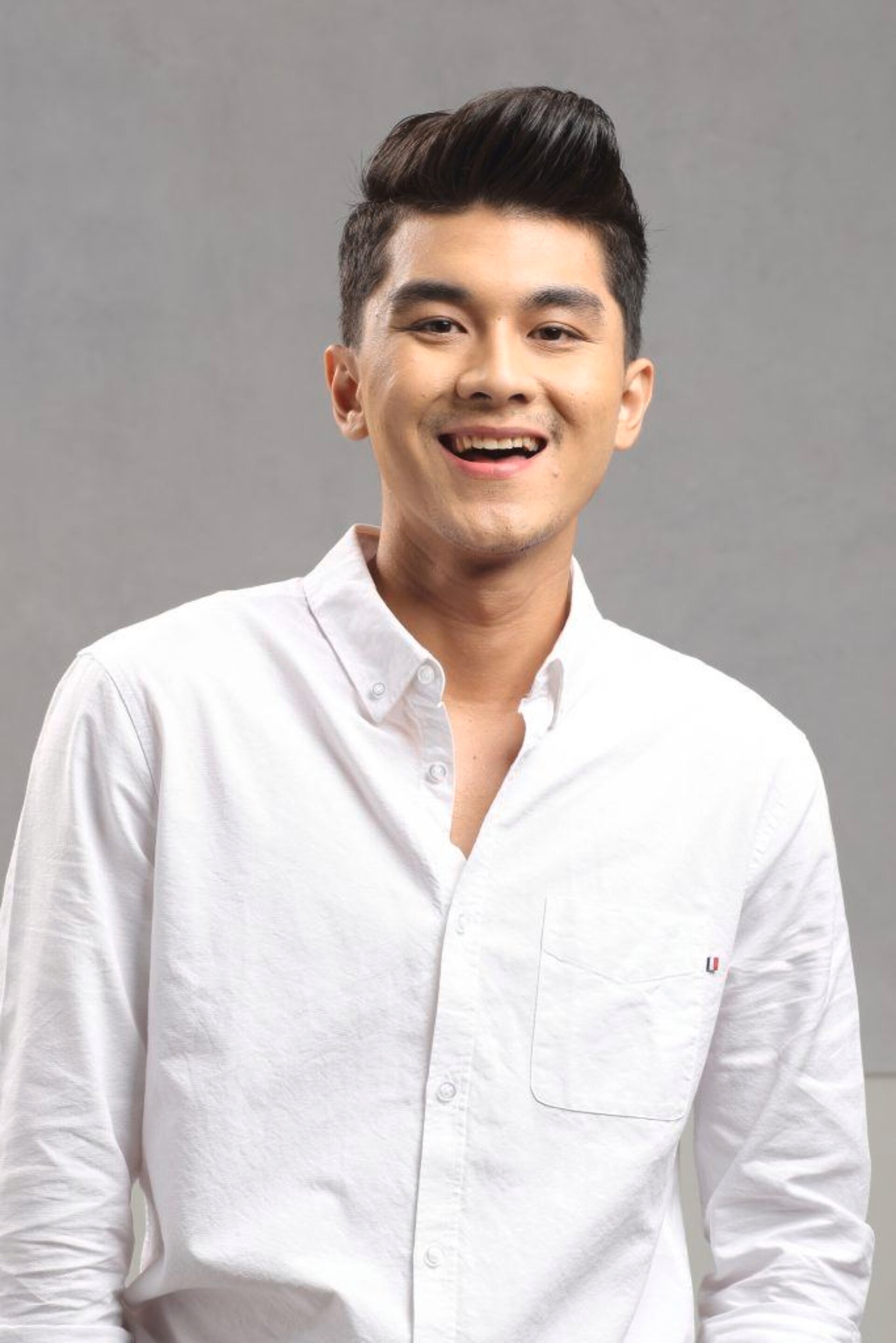 Asian man with thick hair in a pompadour