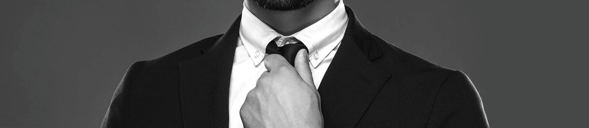 Close up of a man’s suit jacket, shirt and tie teaser.
