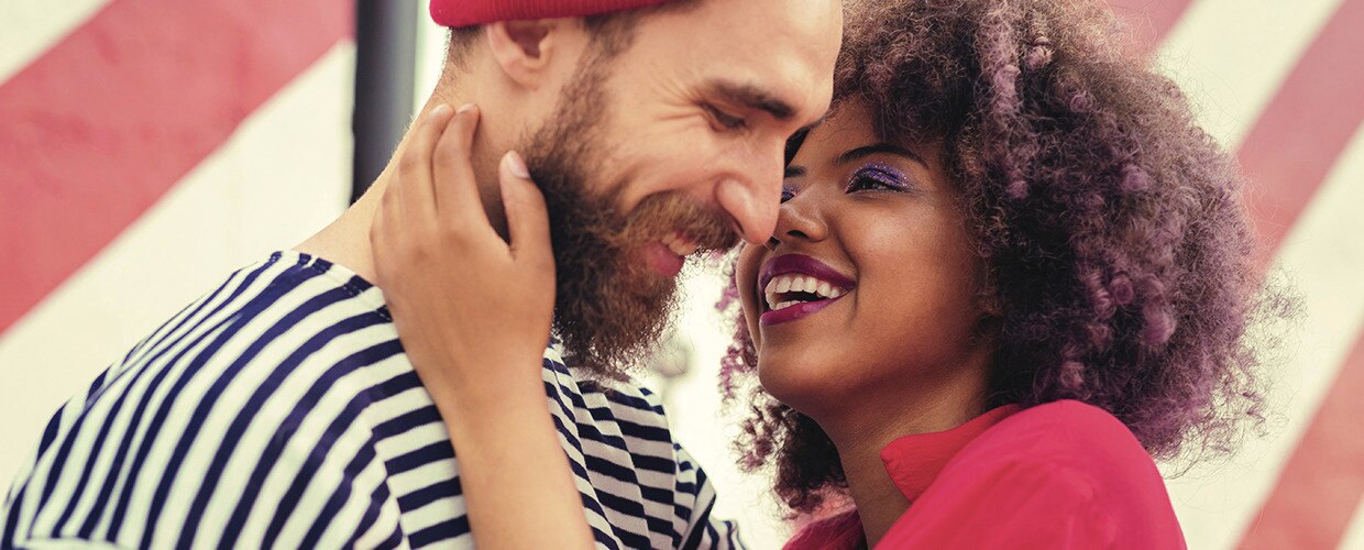 Couple smiling and holding 