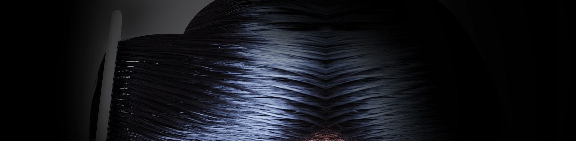 Closeup of sleek black hair being combed