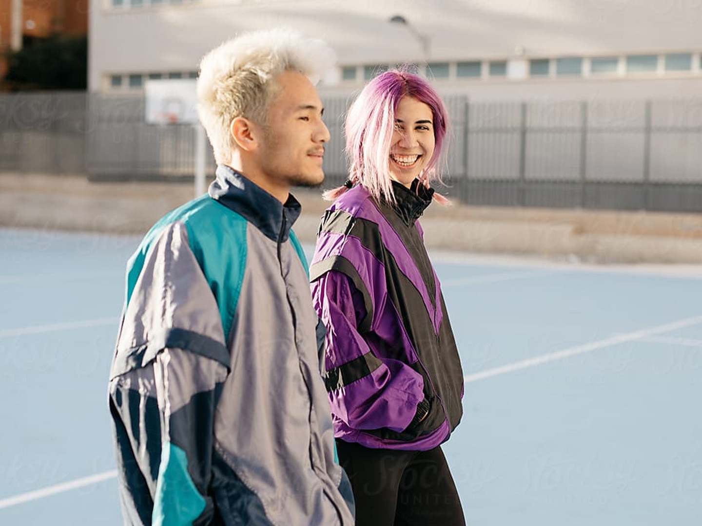 guy and girl talking on a basketball court