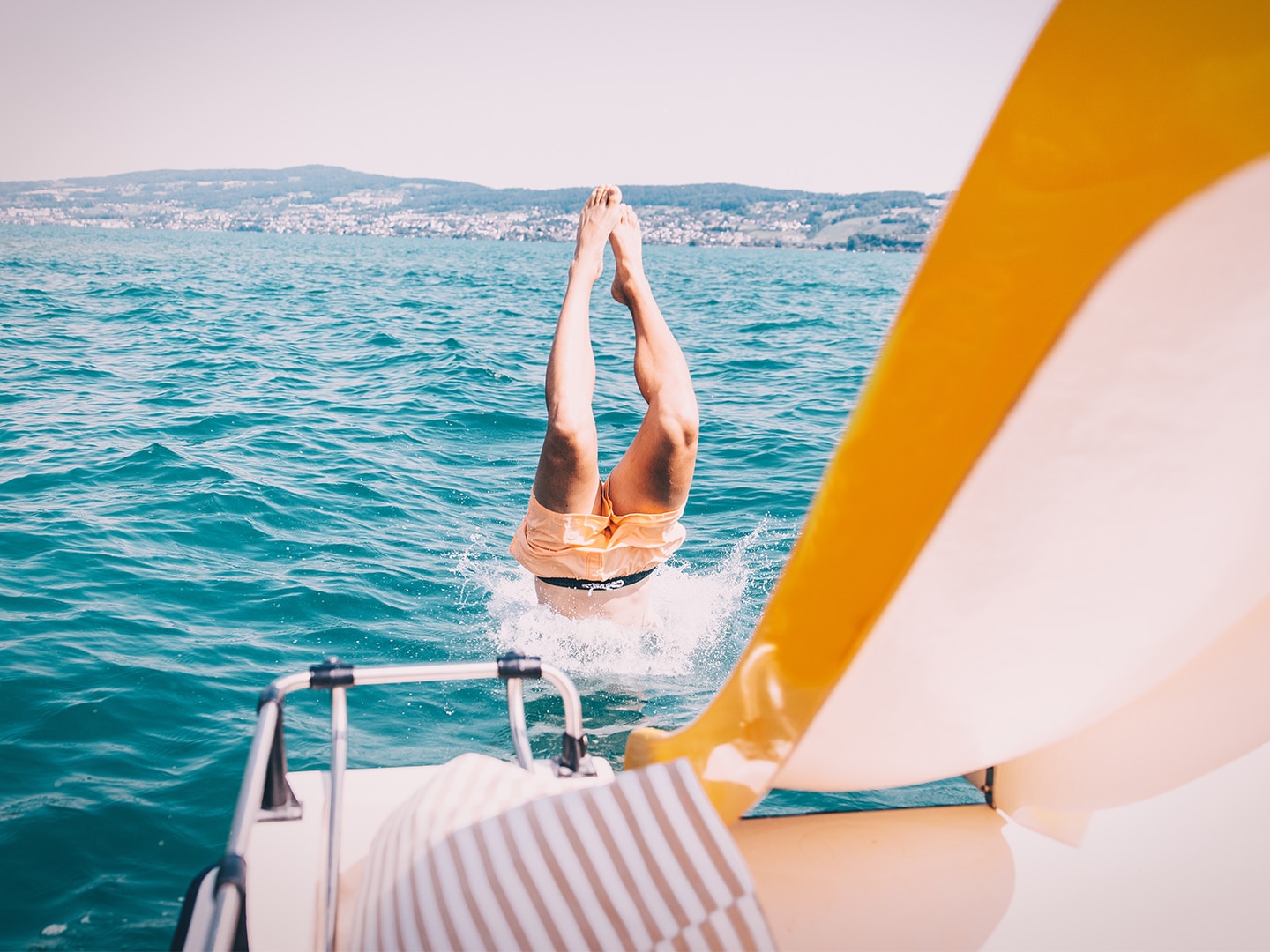a person diving into the sea from a boat