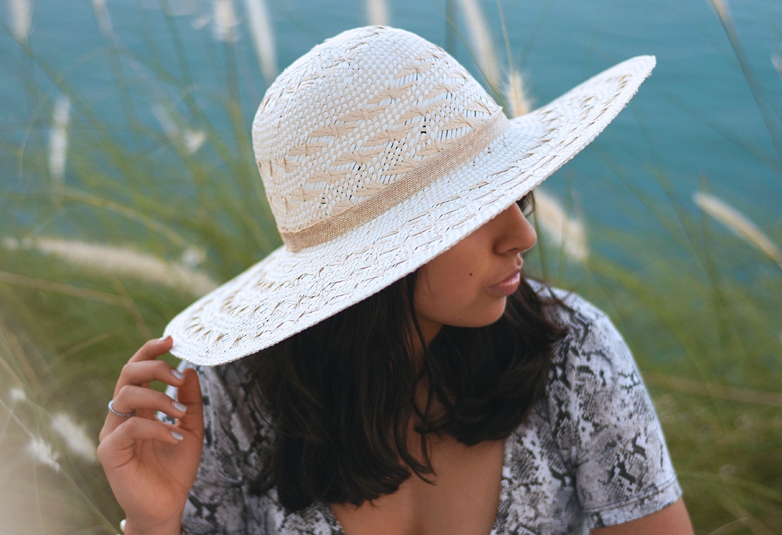 Woman wearing a sun hat to protect her scalp