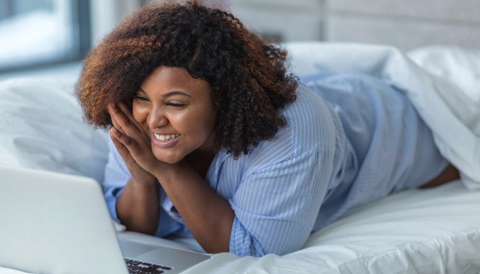 Calm pretty young female lying in the bath with closed eyes