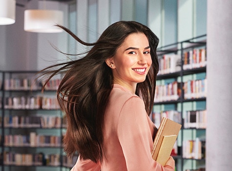 Girl smilling at a library