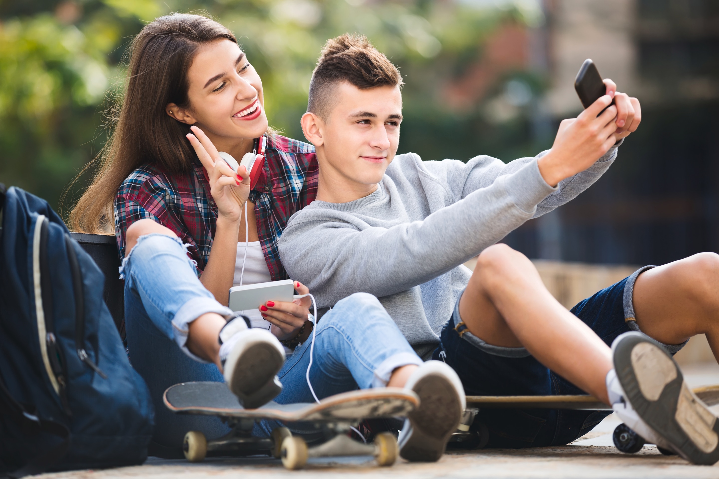 Girl and guy smiling and taking a selfie