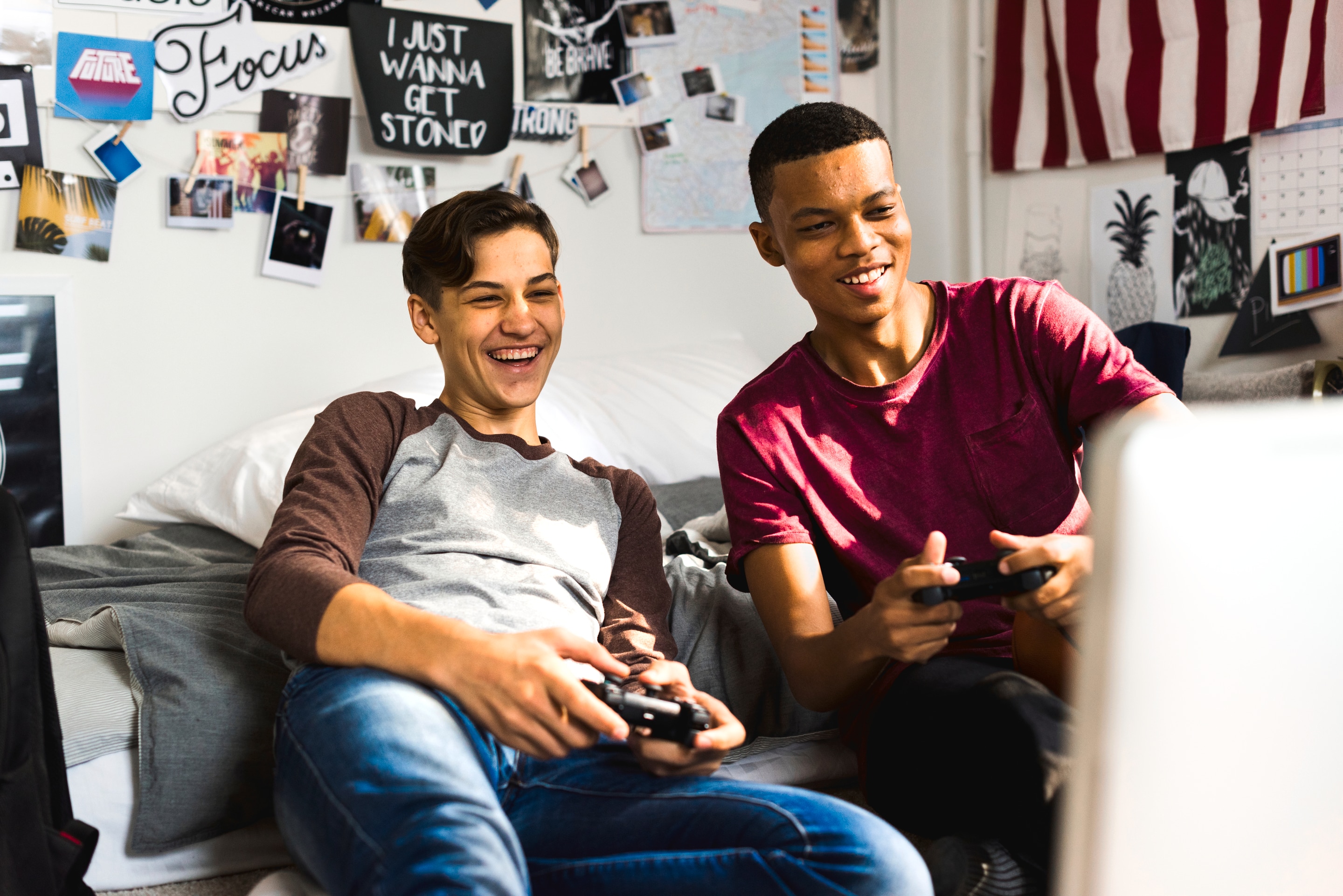 Two guys playing a computer game laughing