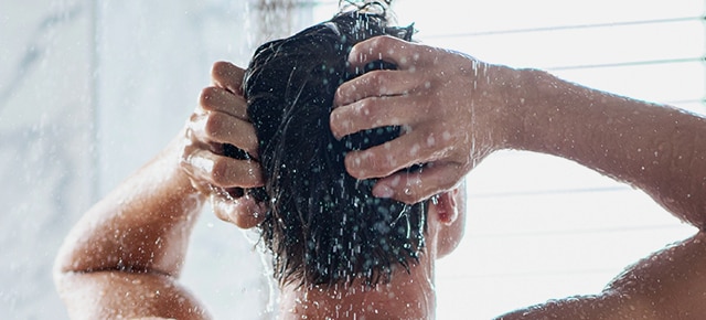 Man washing hair in shower