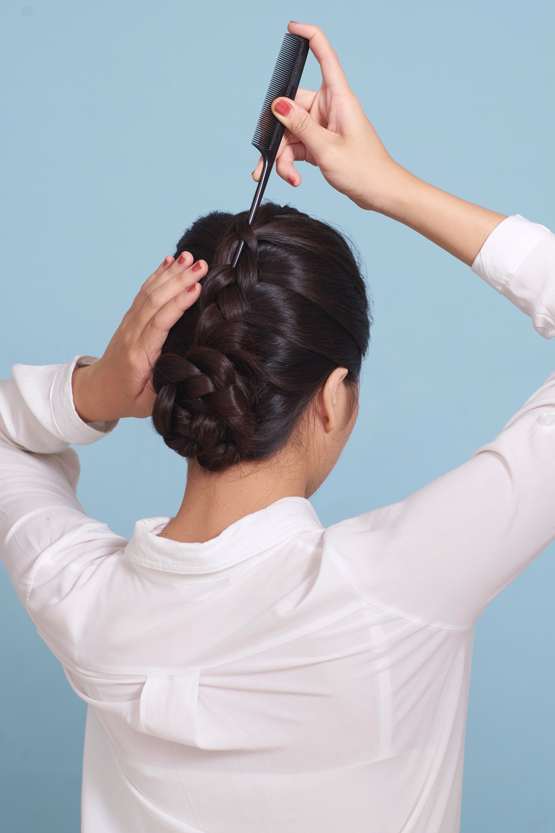 wanita asia sedang melonggarkan sanggul kepang gaya messy