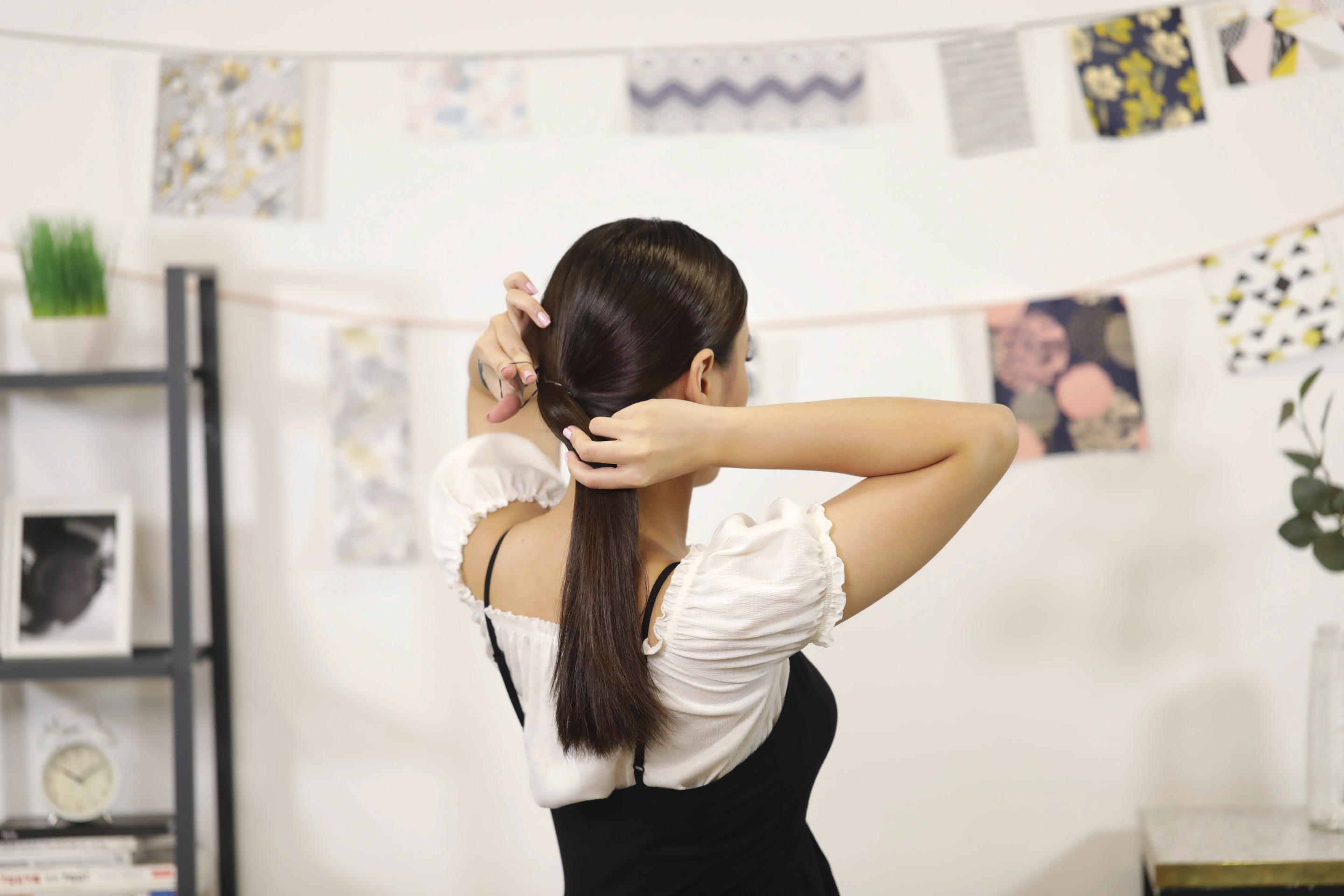 Wanita asia mengikat rambut dalam gaya ponytail untuk gaya sanggul bawah