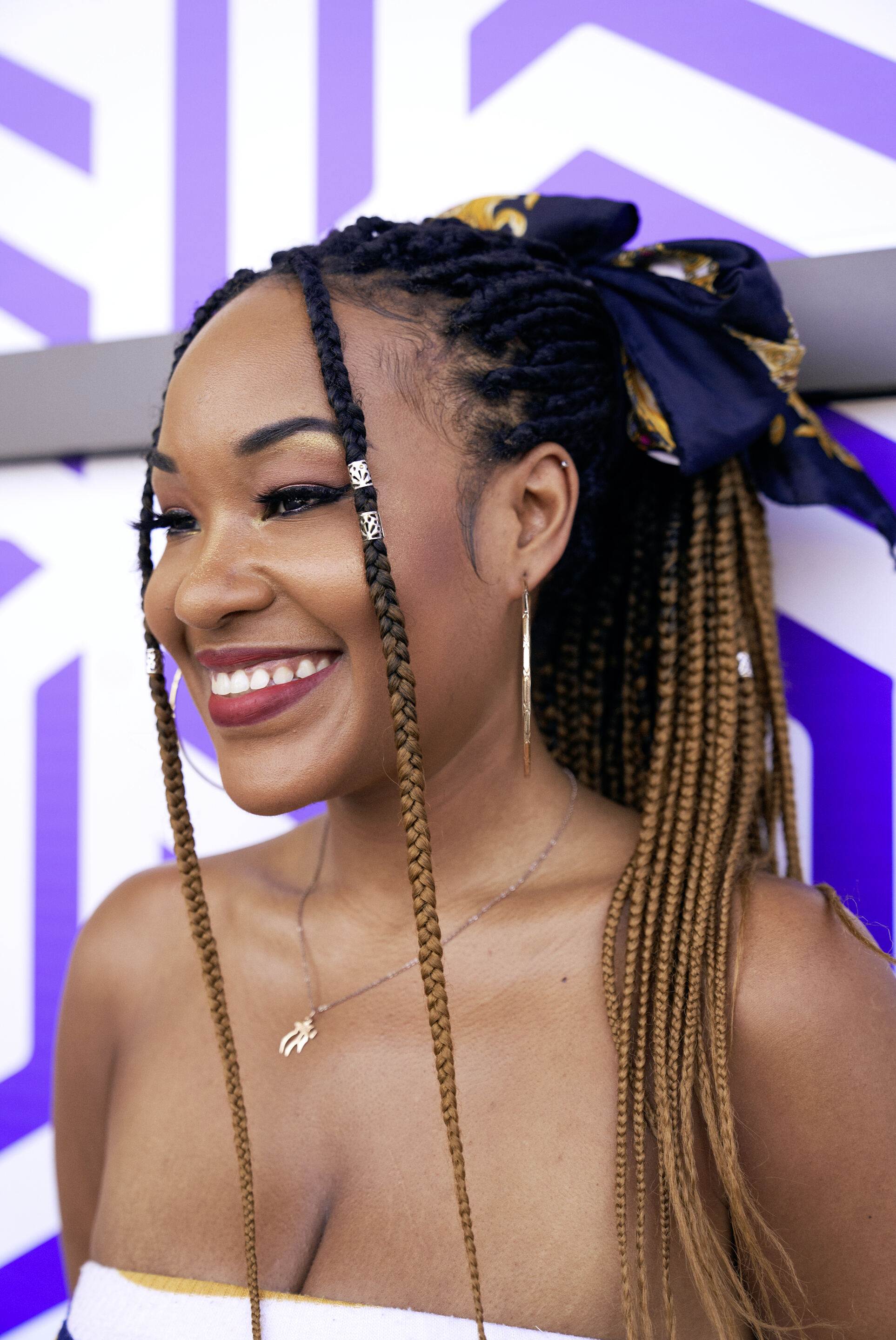 A girl with ombre braids against a purple background