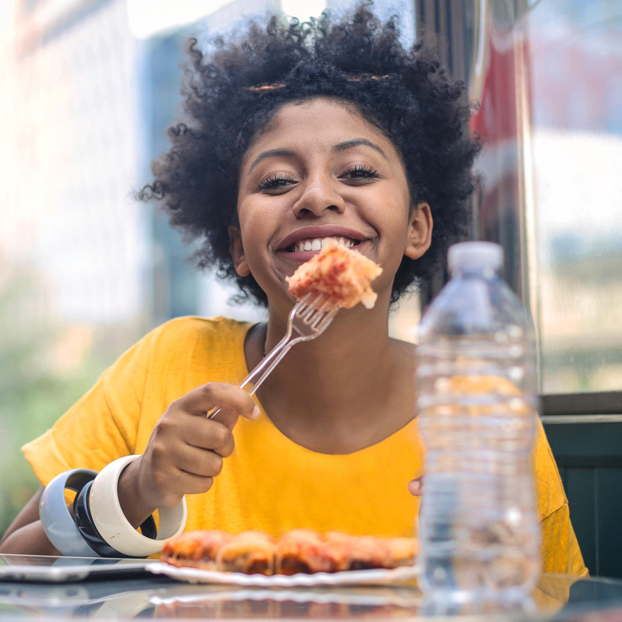 Aromat – a woman smiling with a fork in her hand