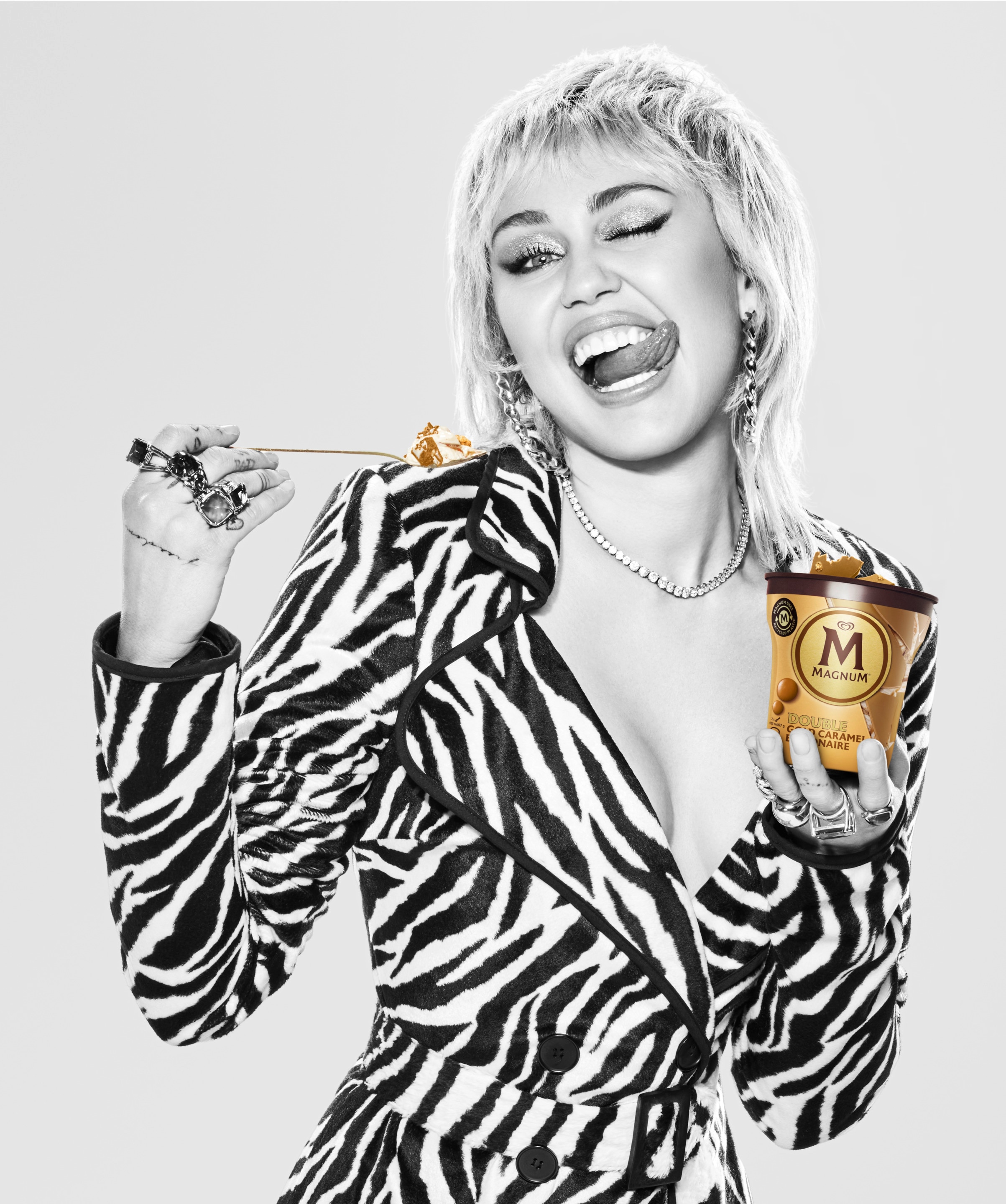 Miley Cyrus singing into a Magnum Double Gold Caramel Billionaire