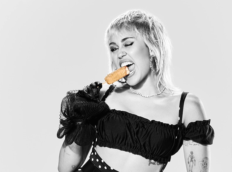 Miley Cyrus biting into her Magnum Double Gold Caramel Billionaire