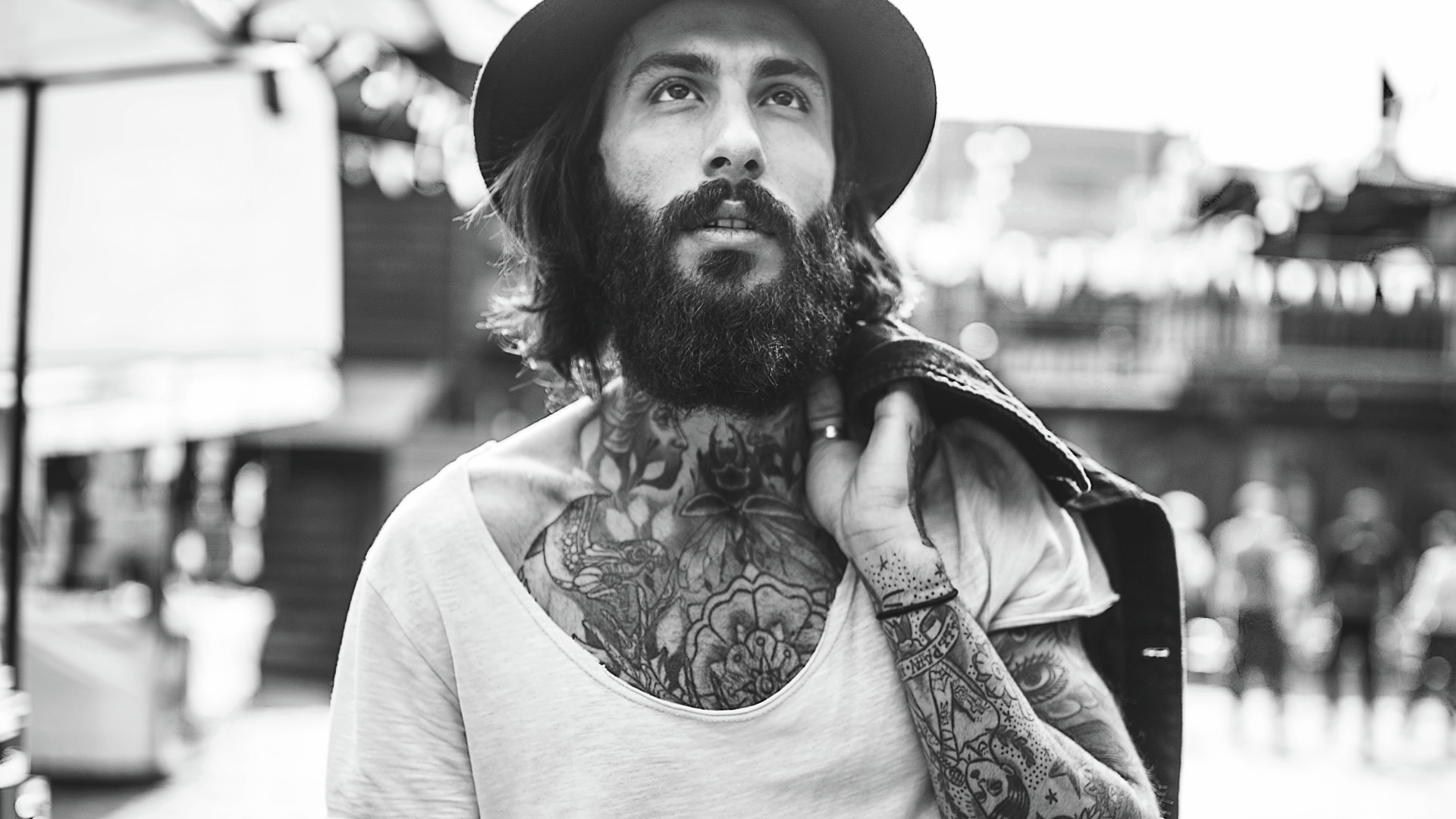 A guy with a full beard and tattoos.