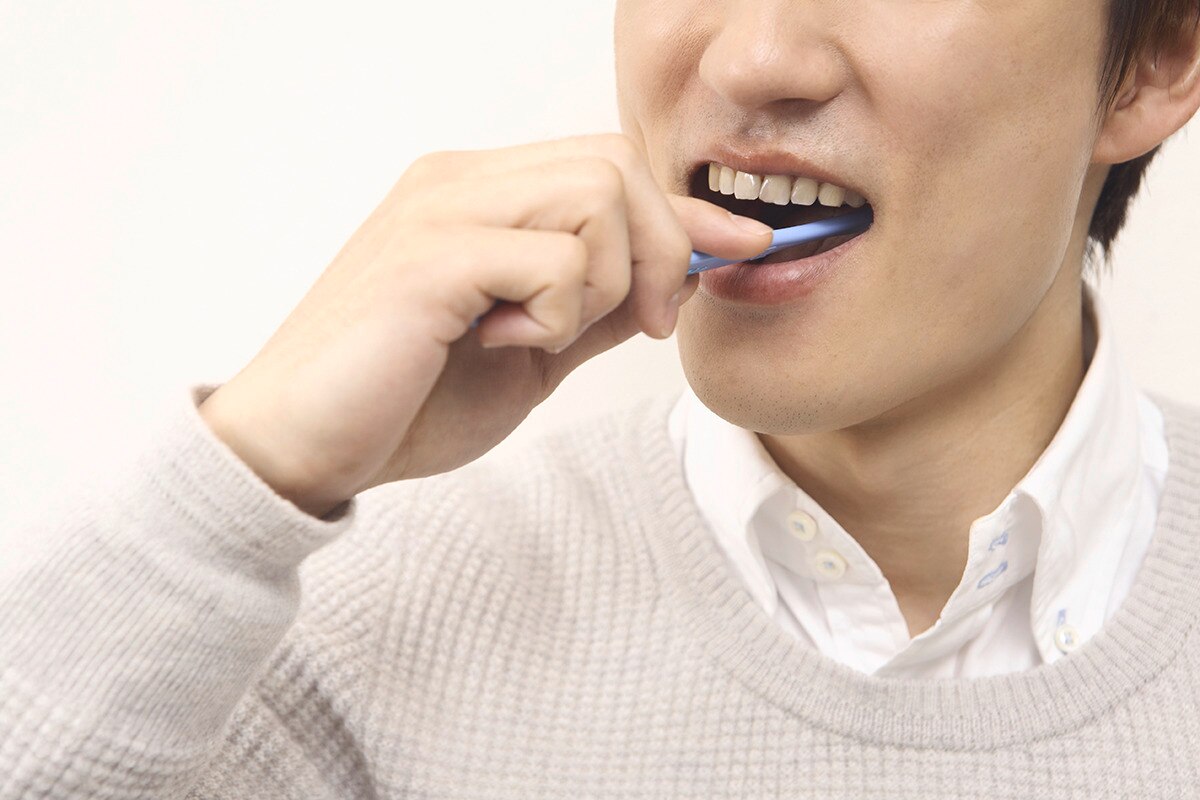 Man is brushing his teeth