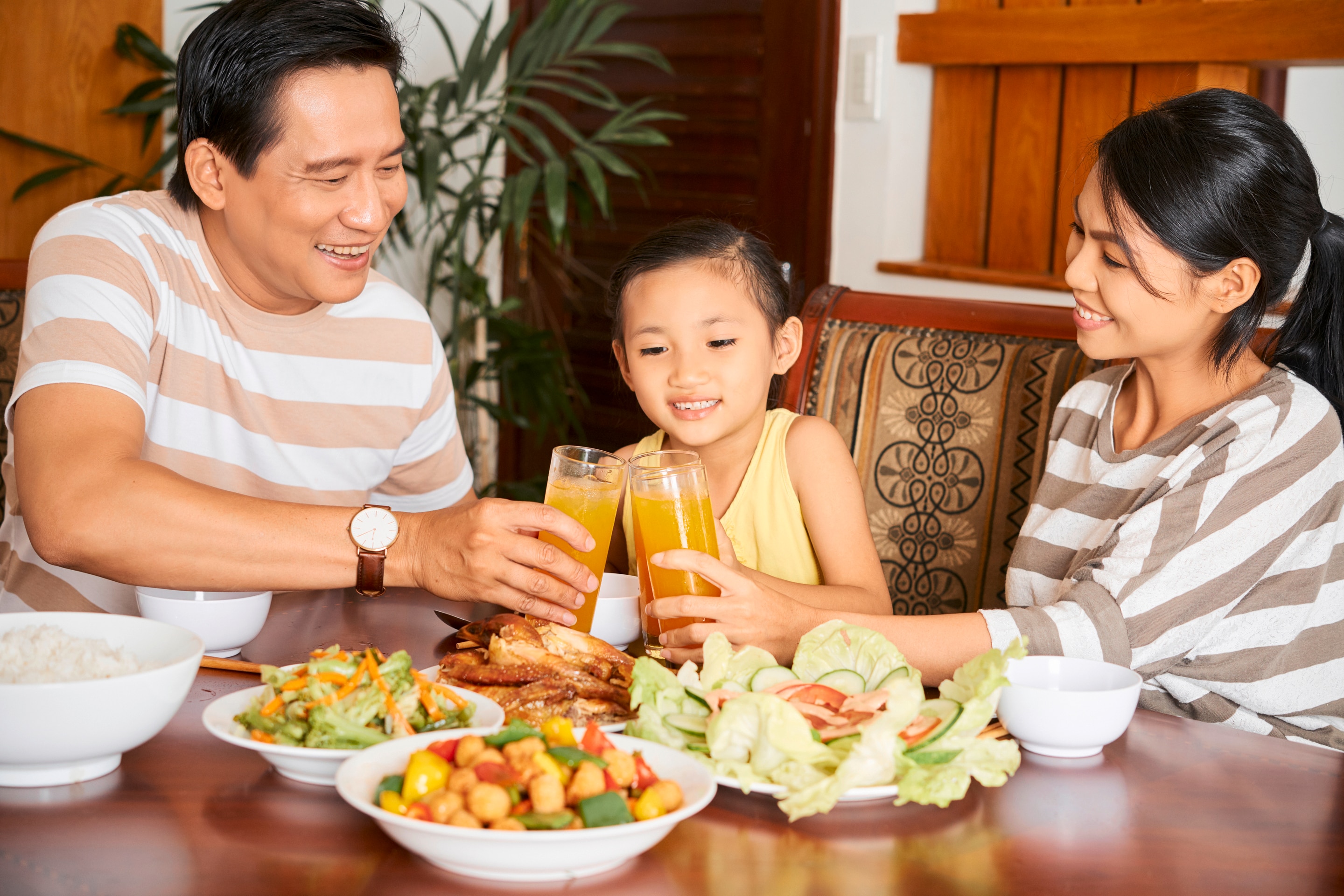 Asian family enjoying vegetables and juice