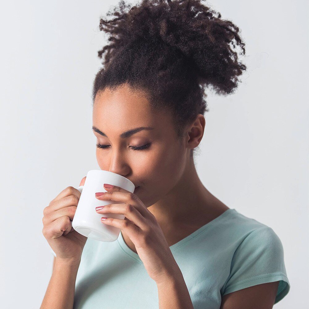 Woman sipping on a cup of tea
