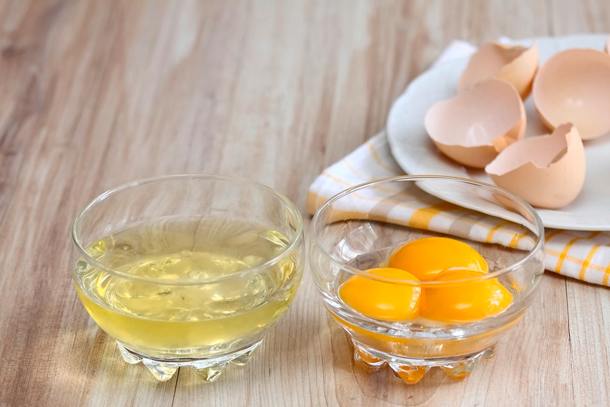 Egg whites and yolks separated into two bowls