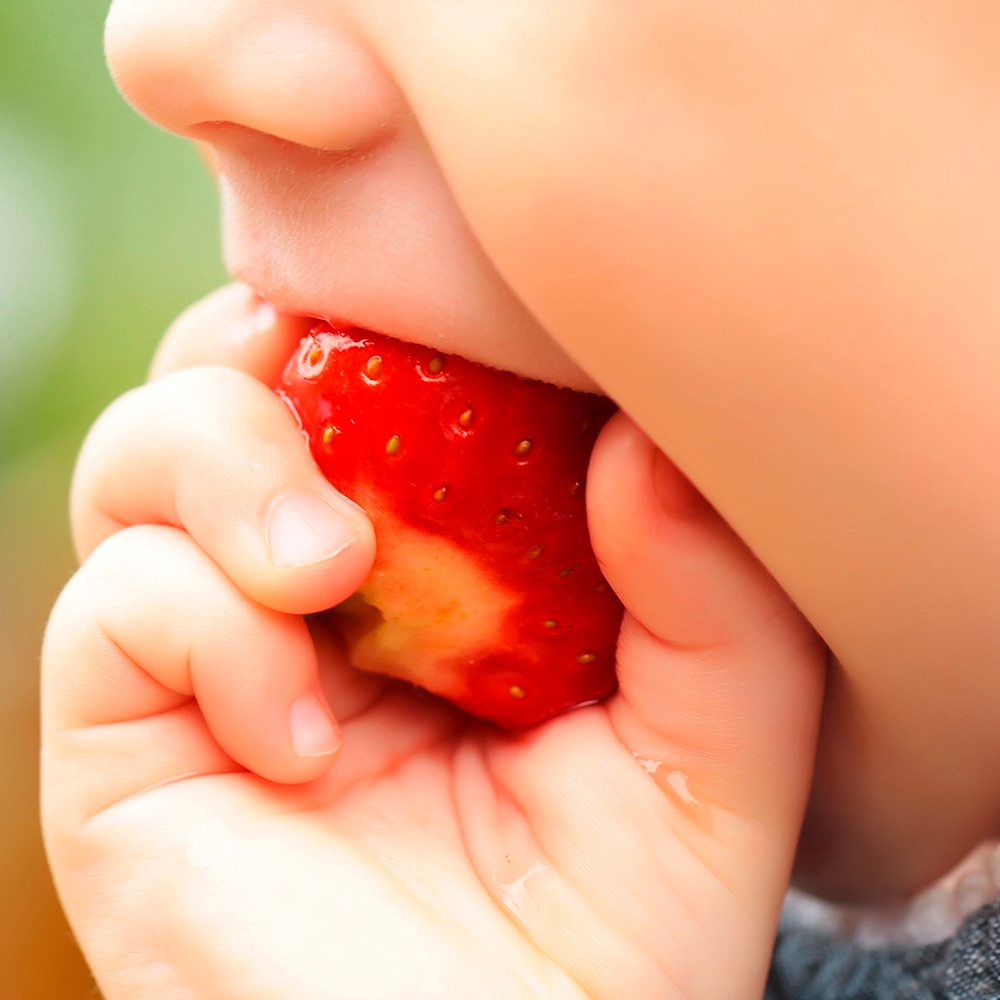 Image of a child eating an apple