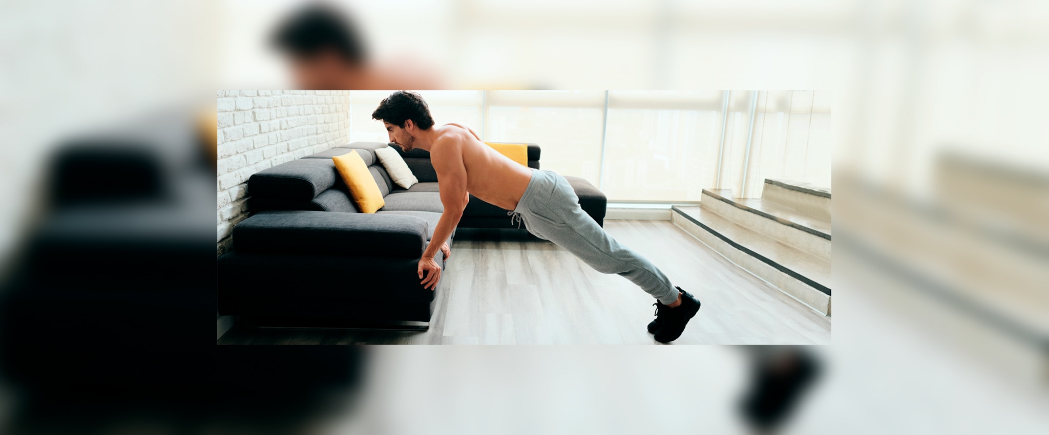 A man doing push ups in his lounge