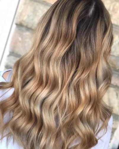 Woman with long wavy golden honey blonde hair
