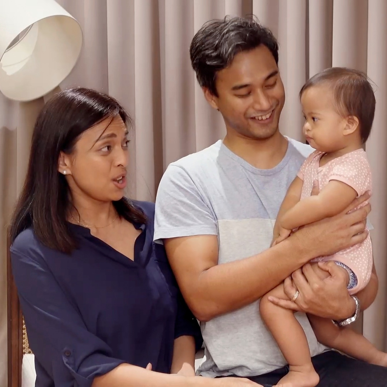 Asian parents talking to their baby