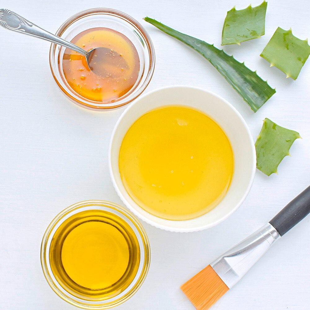 Oils and honey in small white bowls.