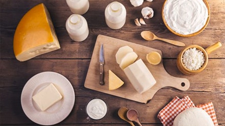 variety of cheeses, flour on a wooden surface