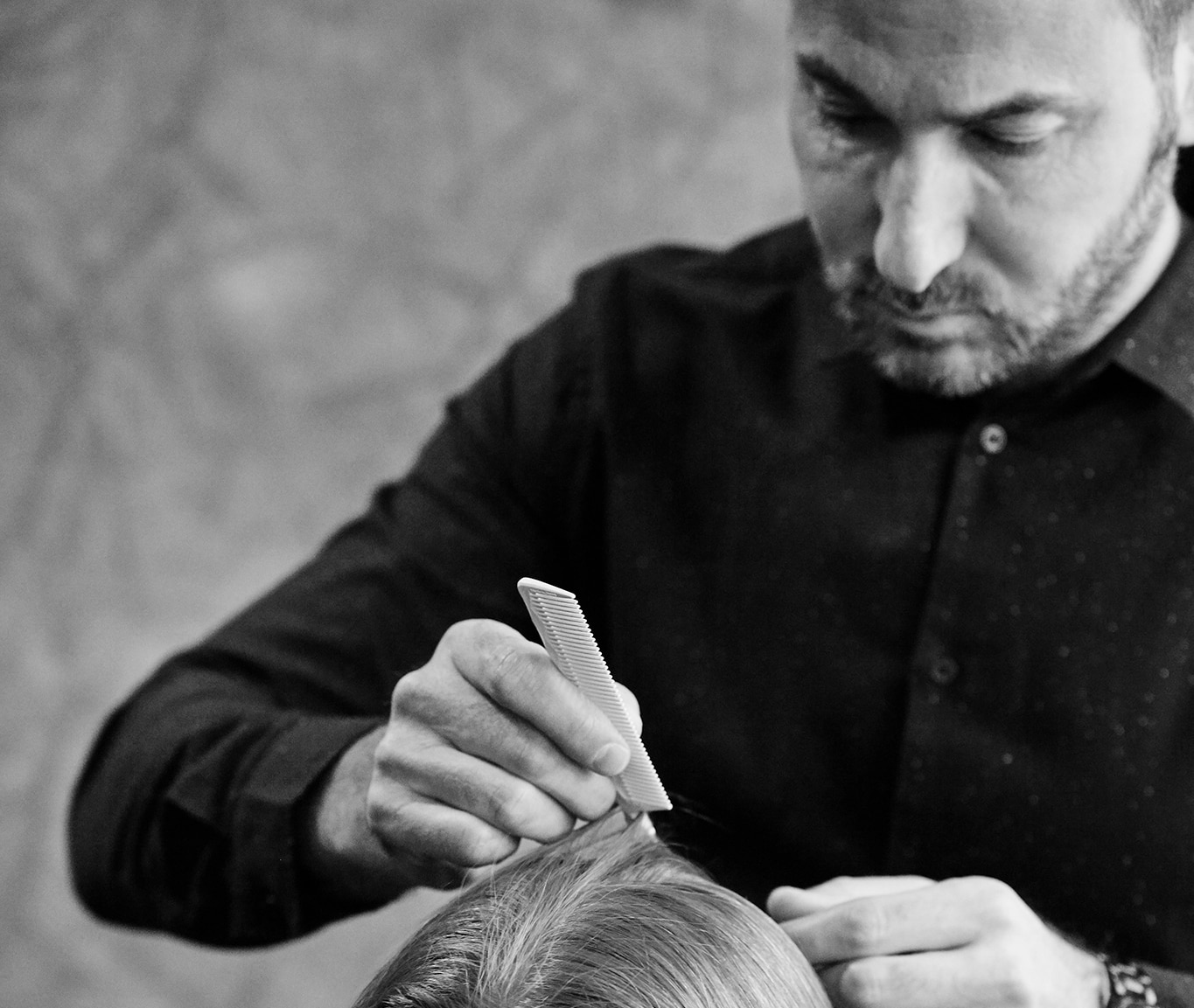 Chris Naselli styling a model's hair with a comb