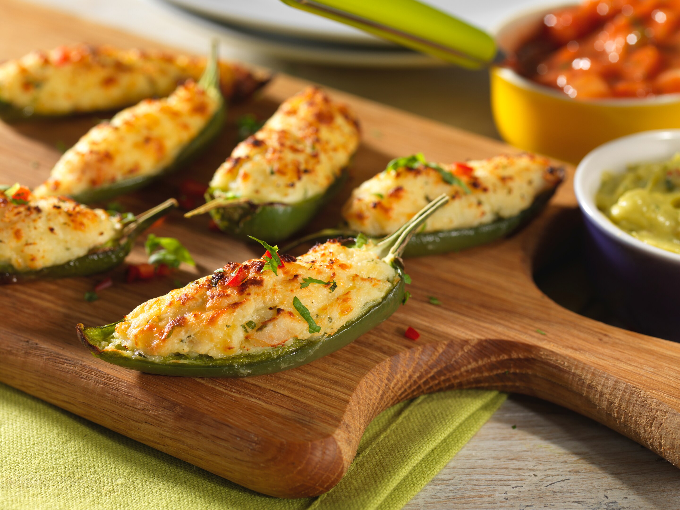 Baked jalapeno poppers with spicy beef and grated cheese