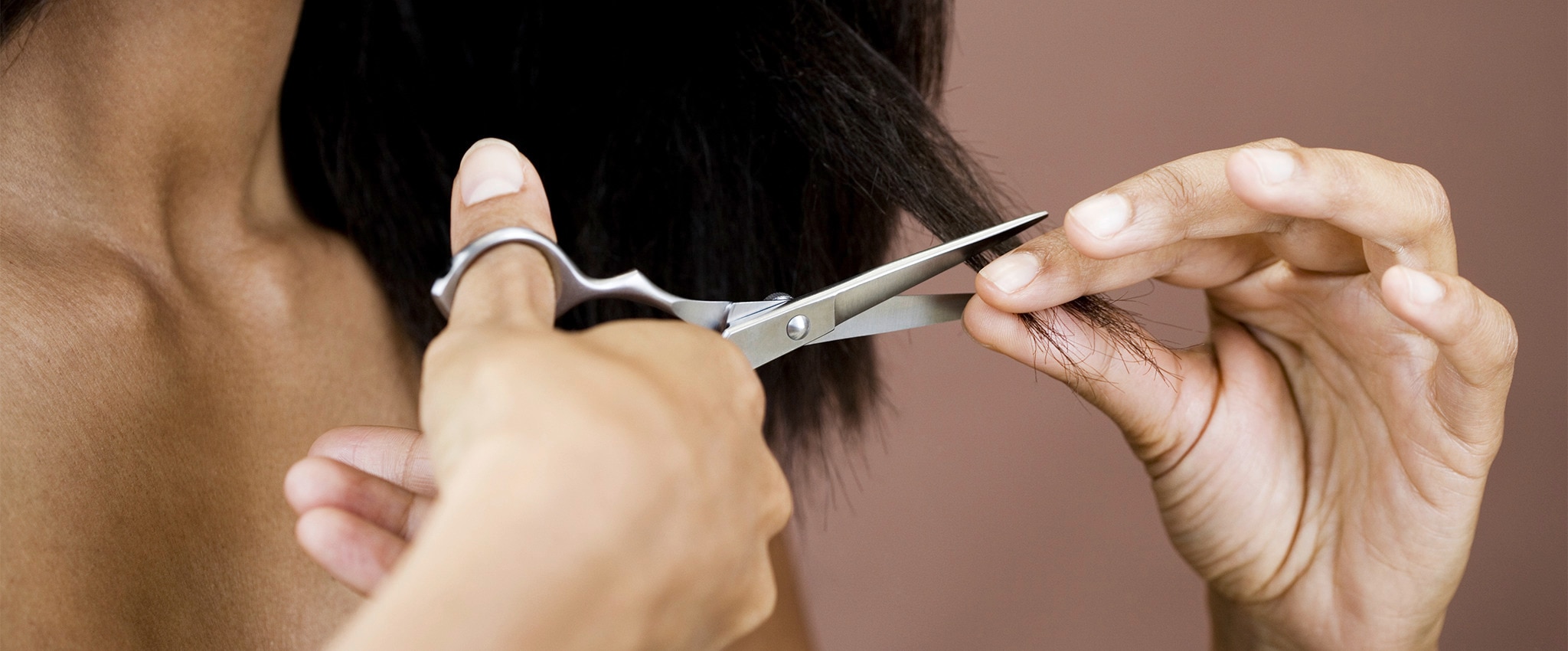 Woman cutting a small portion of her hair