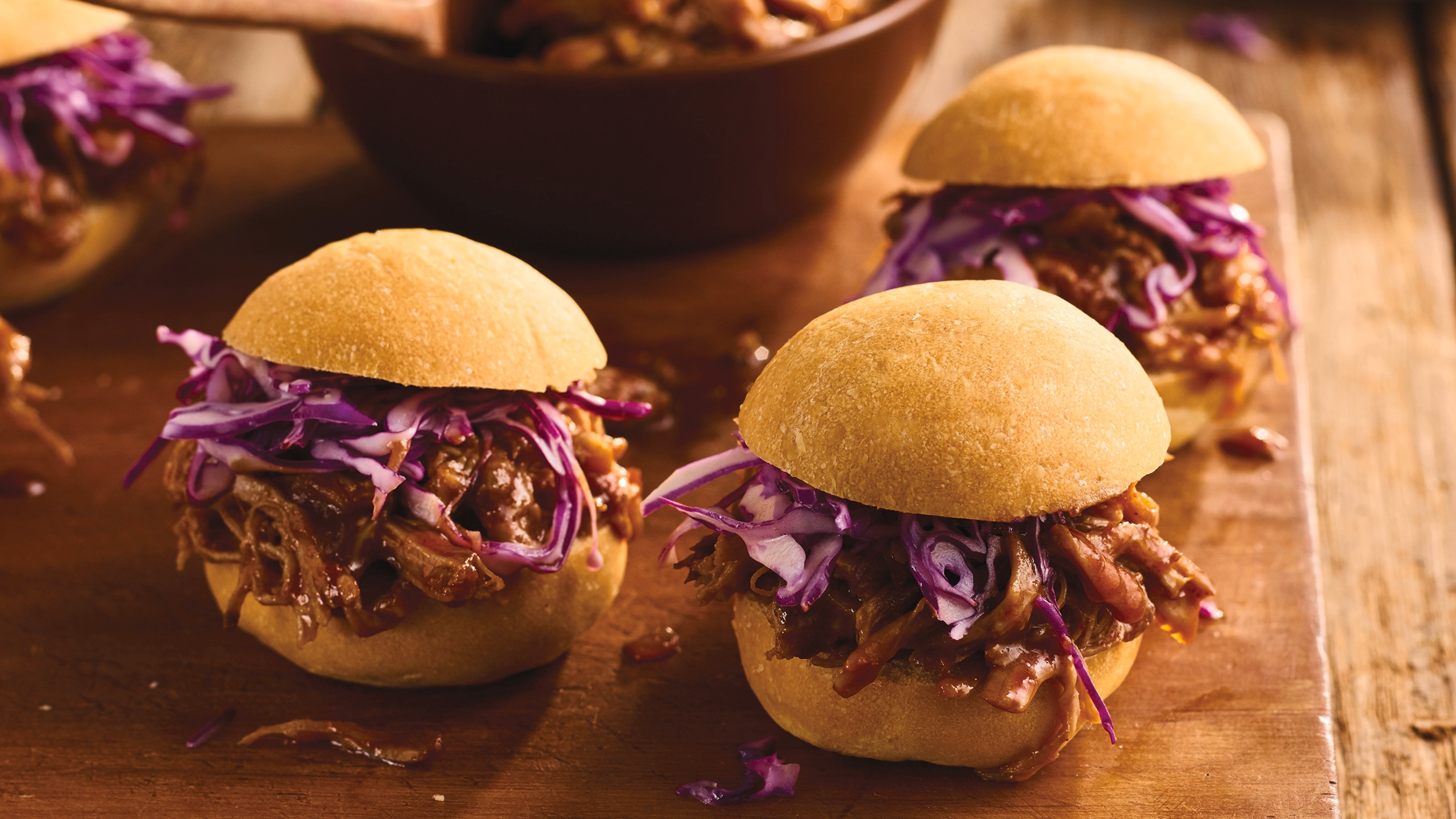 Chipotle slow cooker pulled pork sliders served with purple coleslaw on top