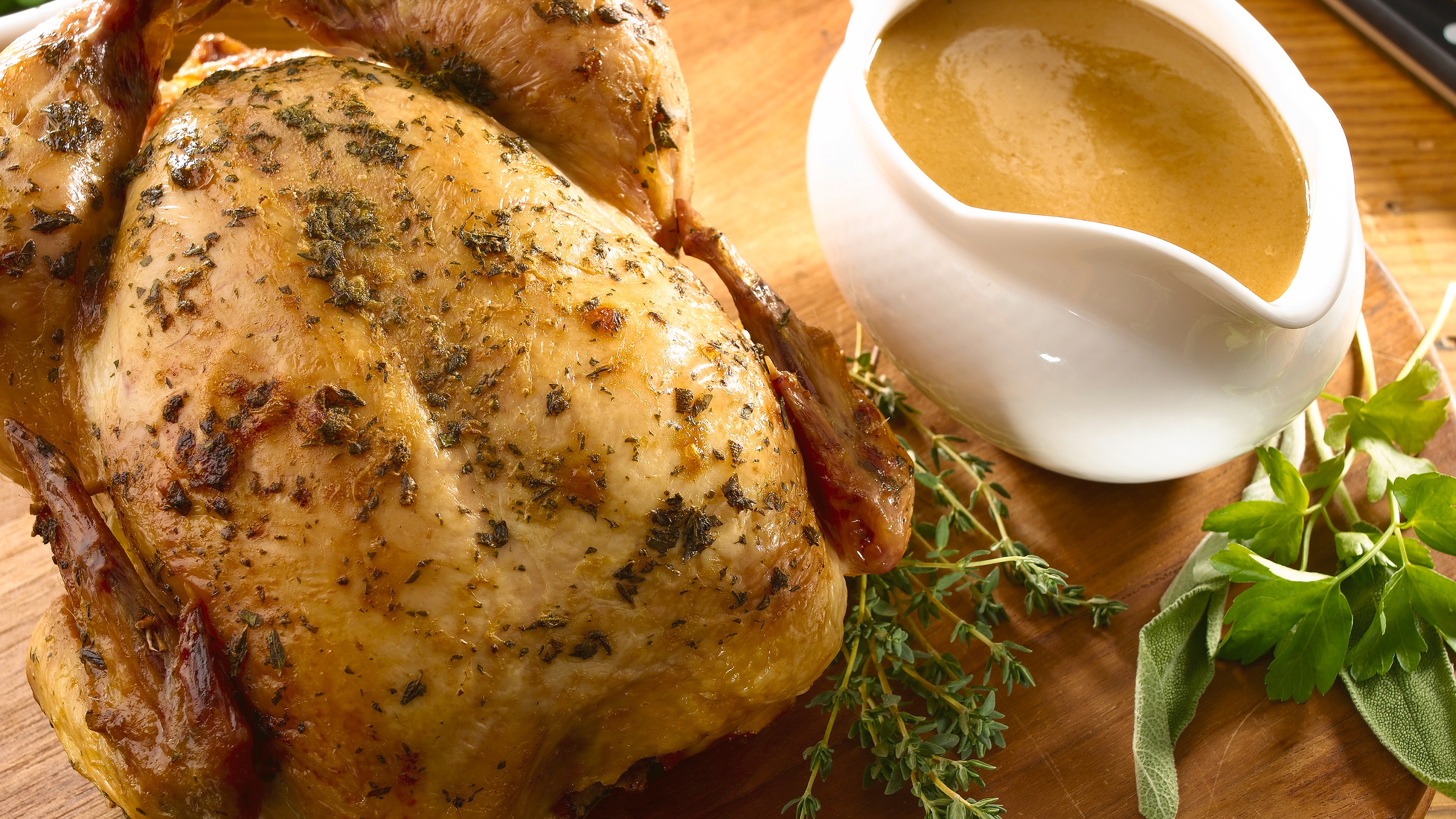 Herb-roasted whole chicken with a full gravy boat