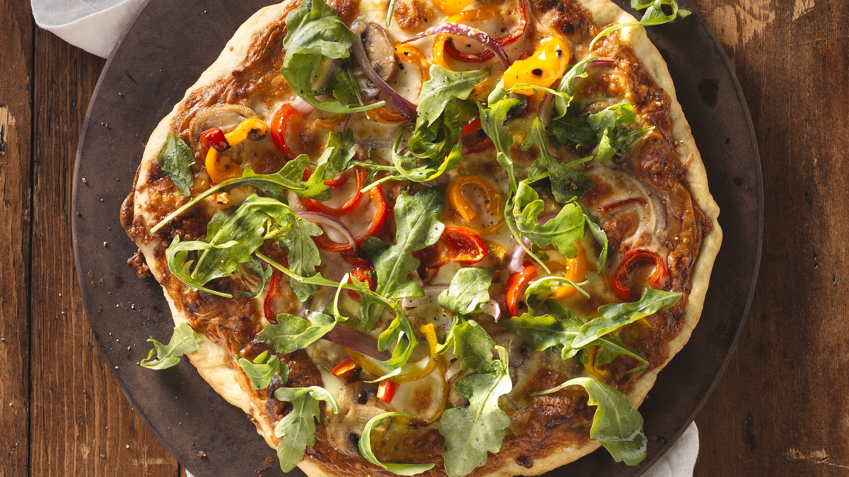 Parma-Rosa Pizza with red and yellow peppers and arugula