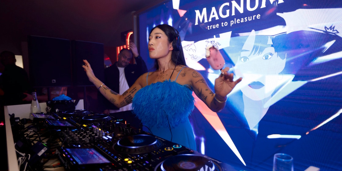 Peggy in DJ booth holding Magnum