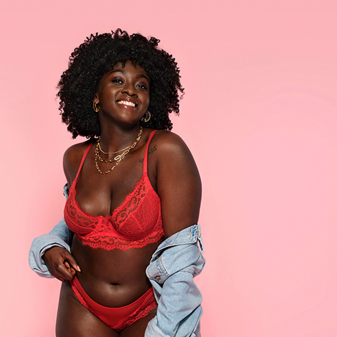 Woman showing off moisturised skin, wearing a denim jacket