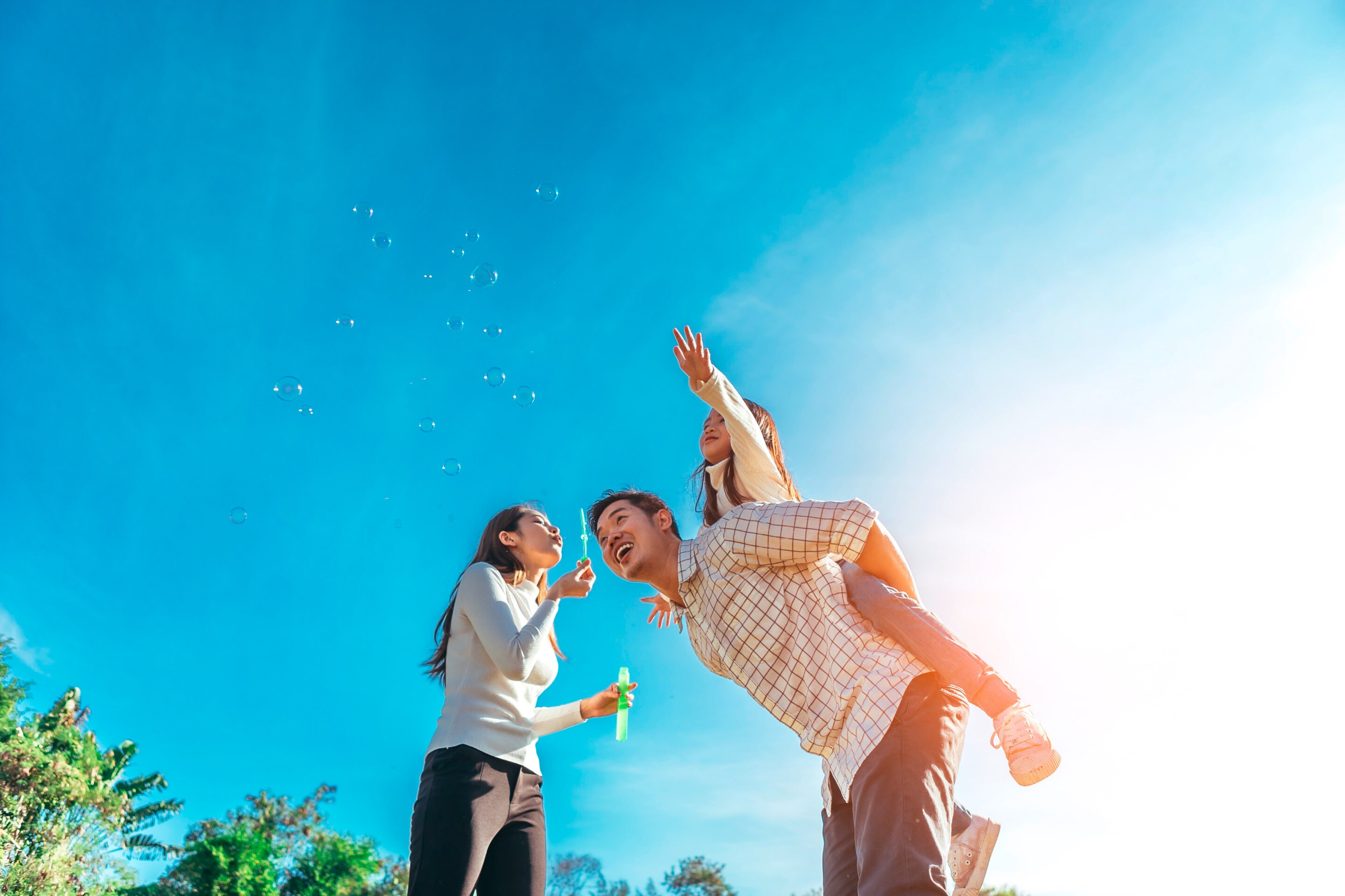 An Asian family playing in the sun together at the park