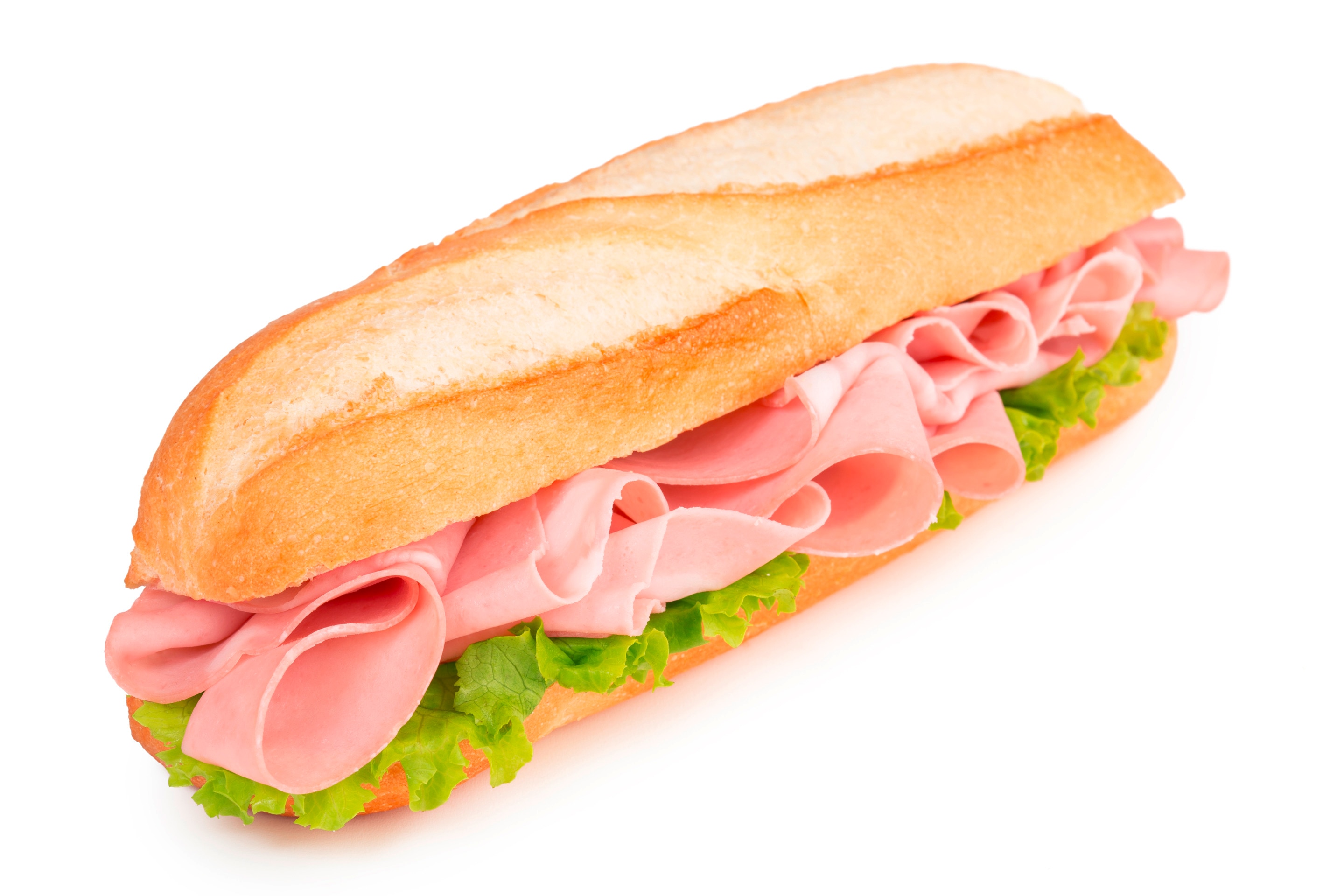A baguette sliced in half and filled with ham and lettuce