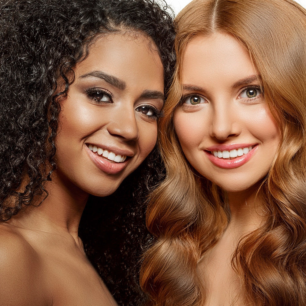 Woman with black natural hair and a woman with long blonde hair