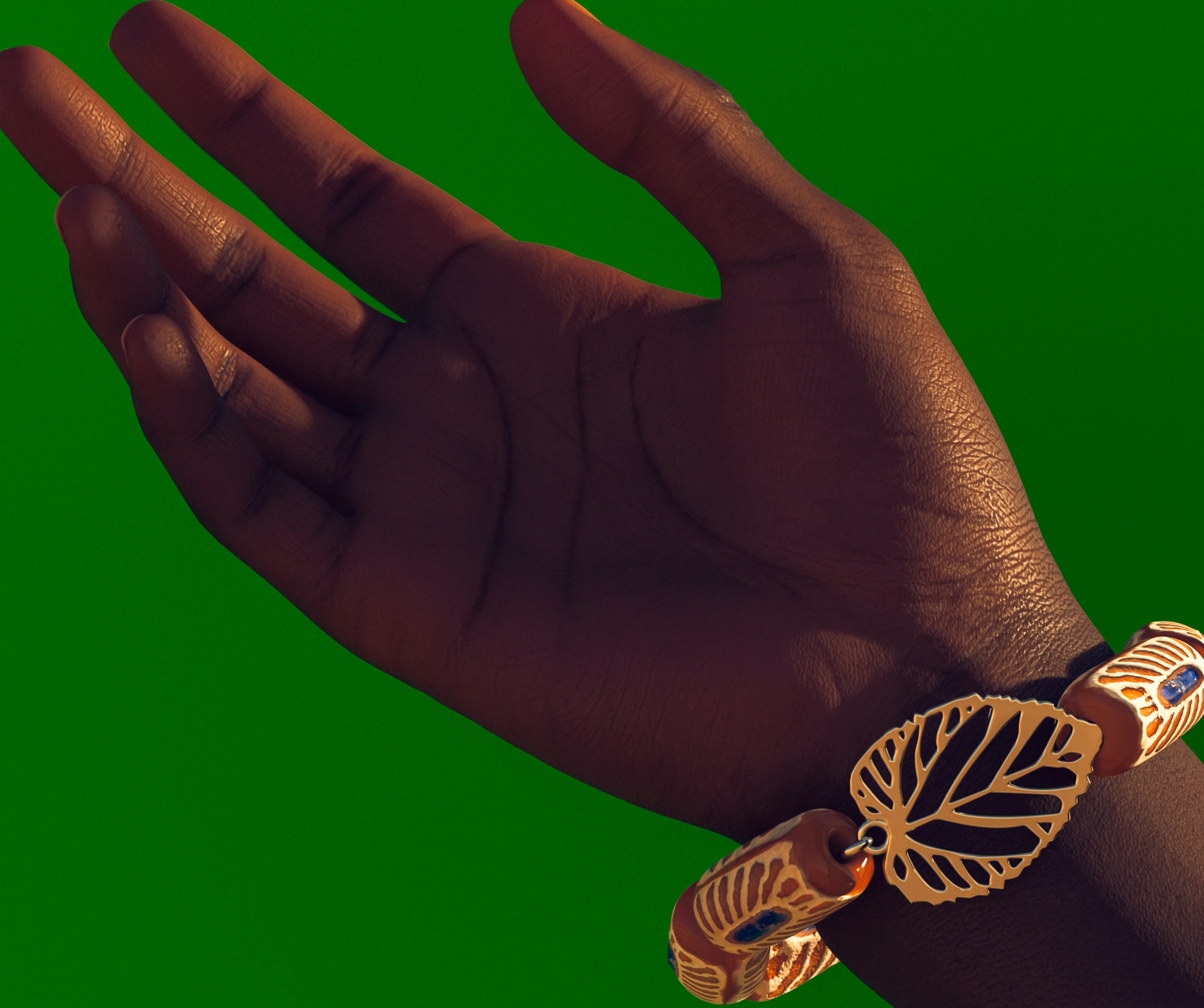 Ivorian style bracelet on a wrist on green background