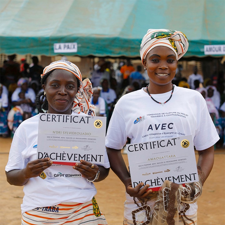 African women holding certificates of achievement