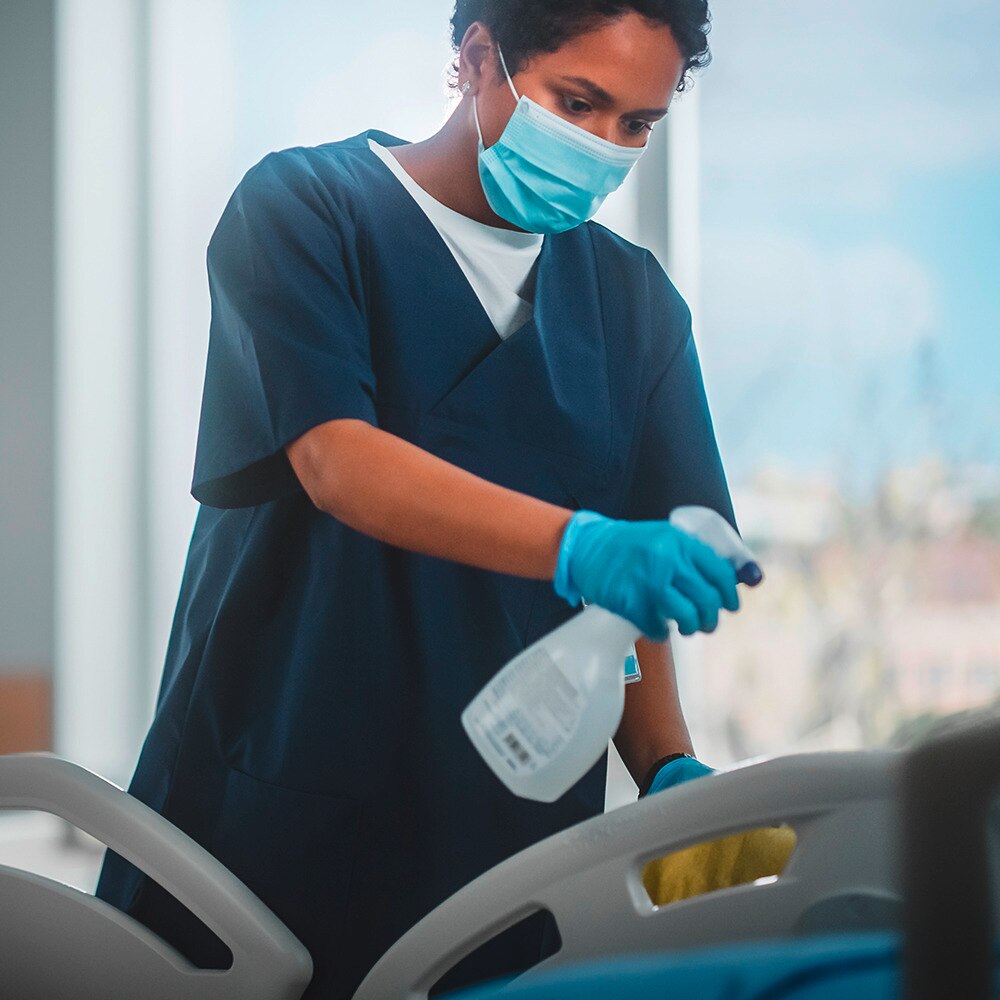 Healthcare worker sanitising hands or equipment