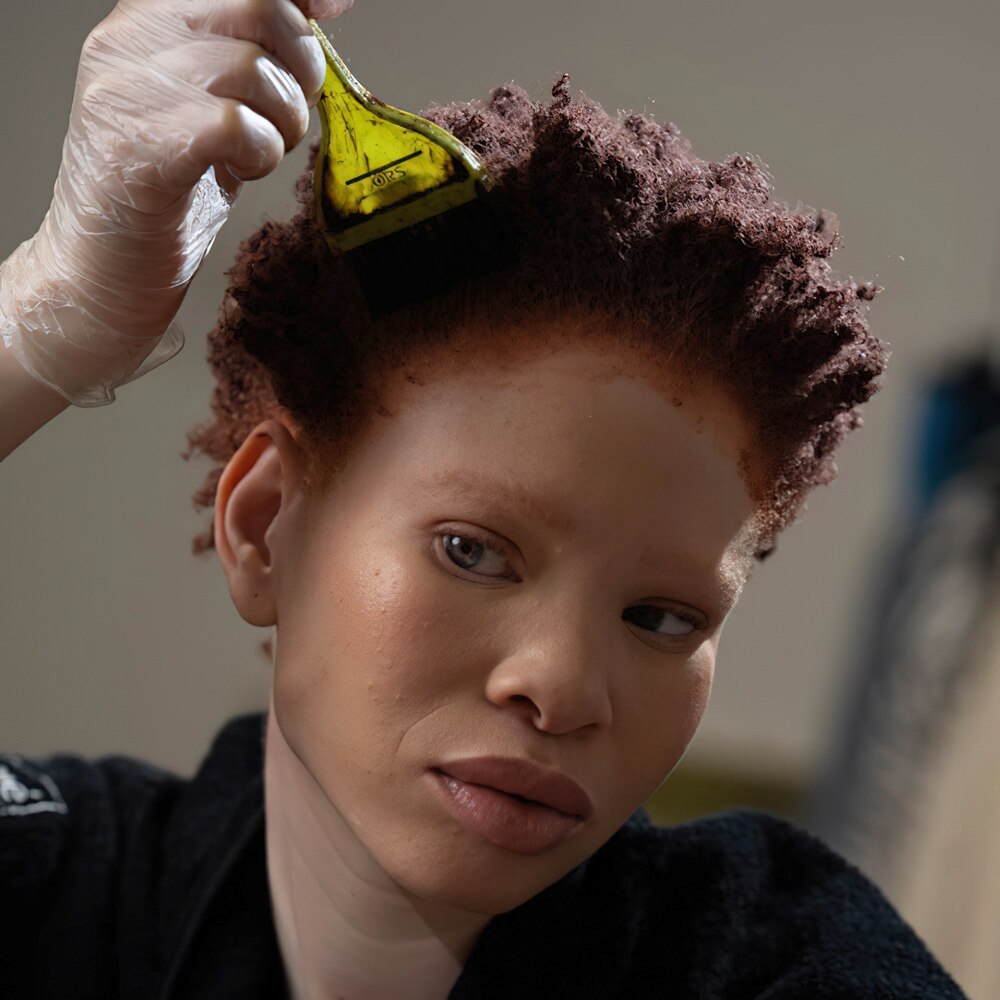 Lady with styling tools around her hair