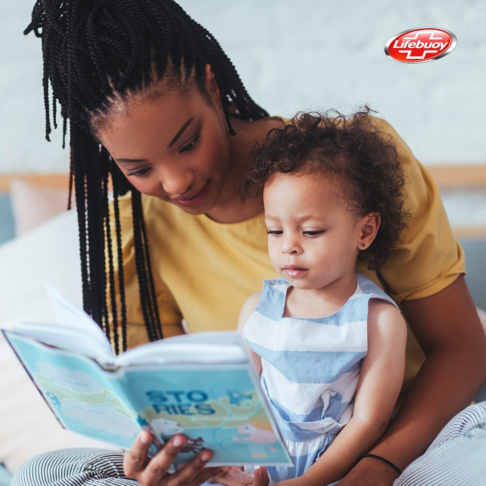 Lady reading a book to a child