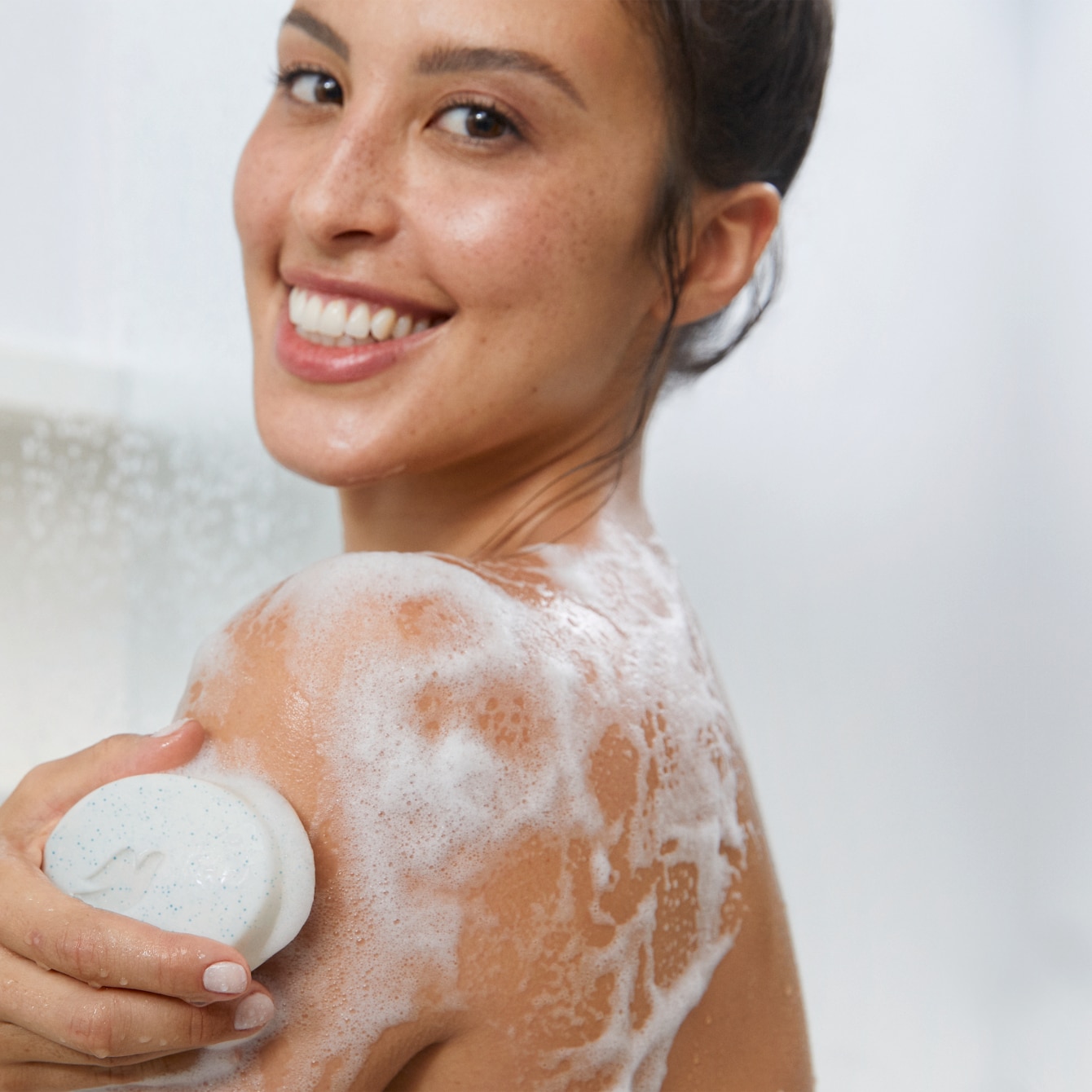 Person showering with cleanser
