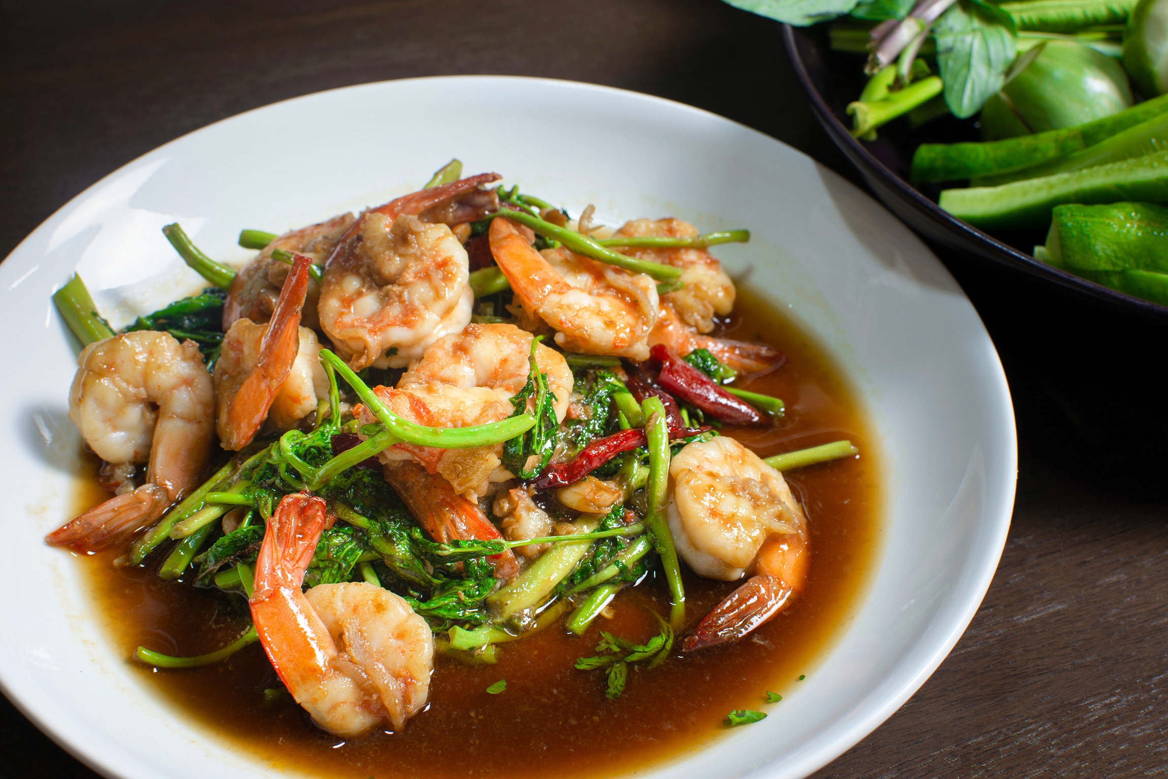 Stir-fried shrimp and kangkong in oyster sauce topped with chilies