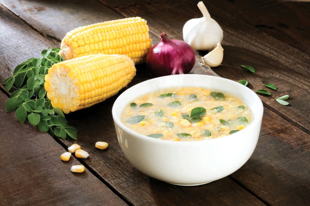Crab and corn soup with malunggay leaves served in bowl